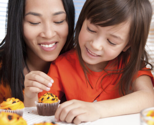 Mother and daughter baking together.