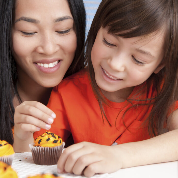 Mother and daughter baking together.