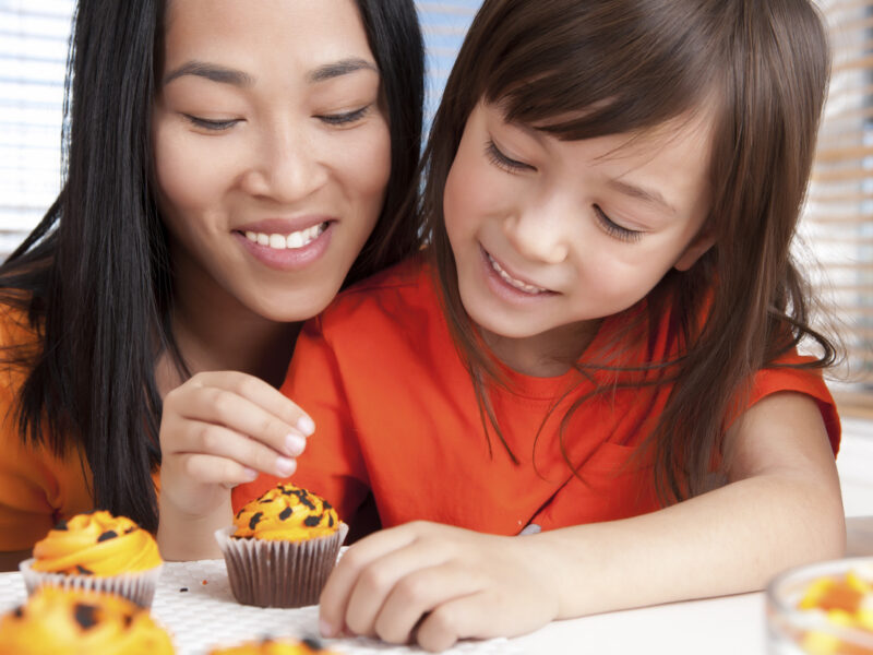 Mother and daughter baking together.