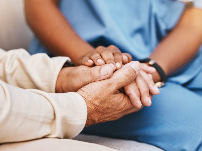 Image of two people holding hands