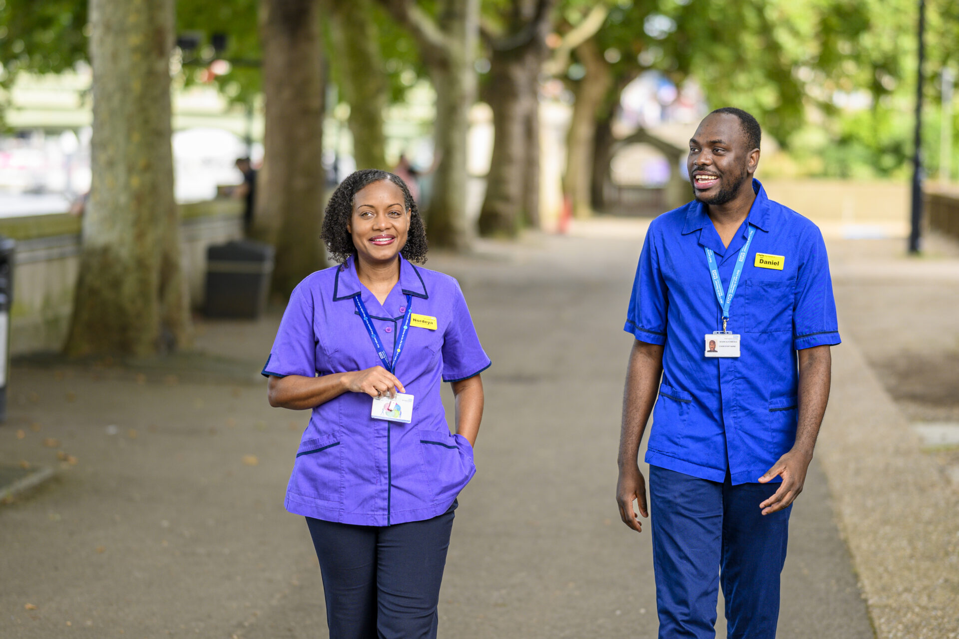 Two colleagues one on the right in a blue uniform, on the left she