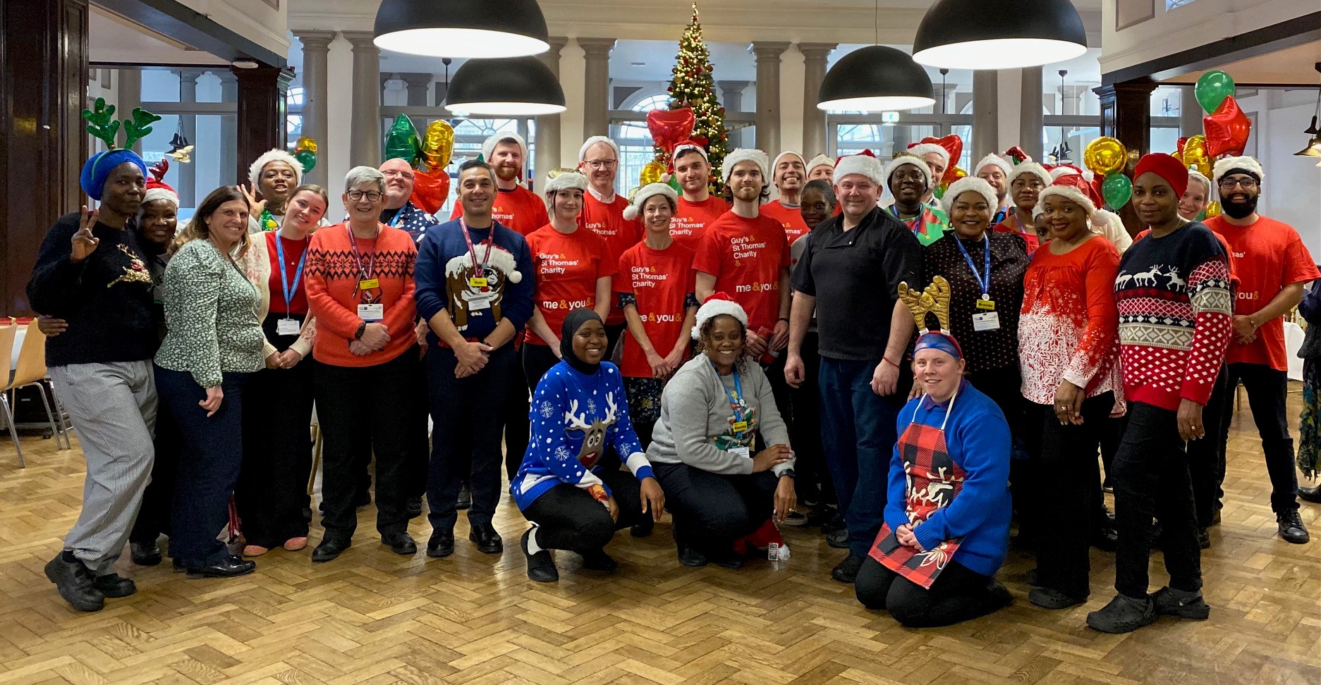 Image of charity and trust staff in festive outfits at Guy