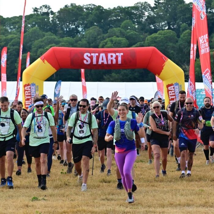 Ultra Challengers at the start of the race. In the background is an inflatable red sign in white writing reads 