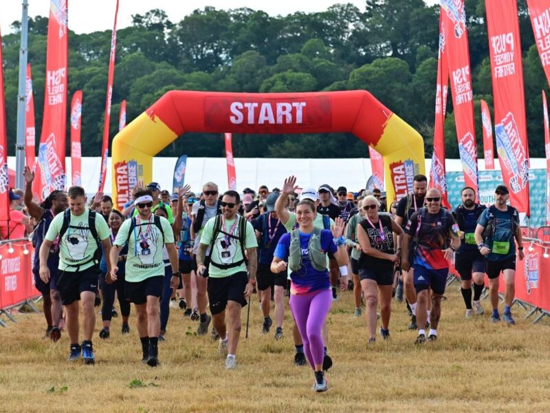 Ultra Challengers at the start of the race. In the background is an inflatable red sign in white writing reads 'Start', there are numerous red long flags around them.