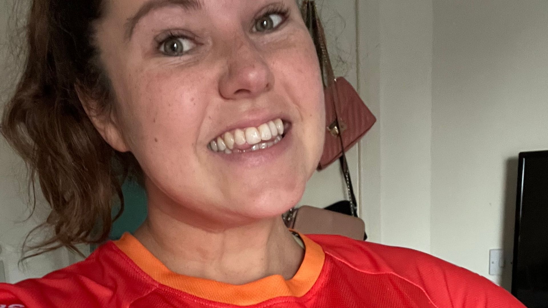 Sarah-Jane wearing a red t-shirt that reads 'Guy's & St Thomas' Charity' on the front.